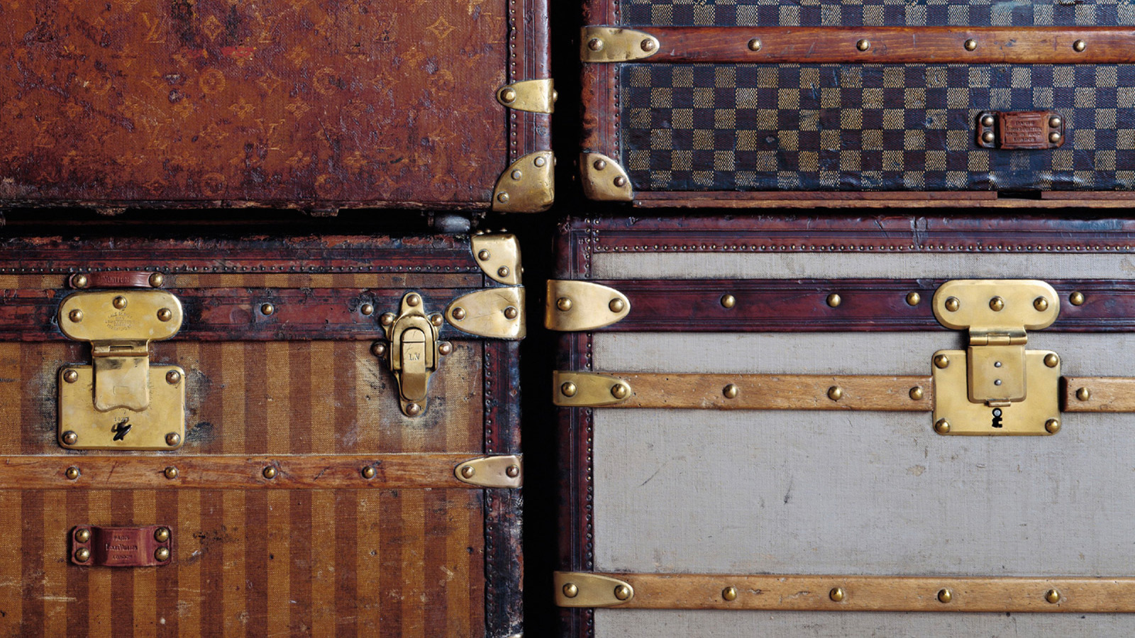 Louis Vuitton trunks, Clockwise from top left The Monogram canvas (1896), the Damier canvas (1888), the Trianon gray canvas (1854), and the striped canvas (1872)